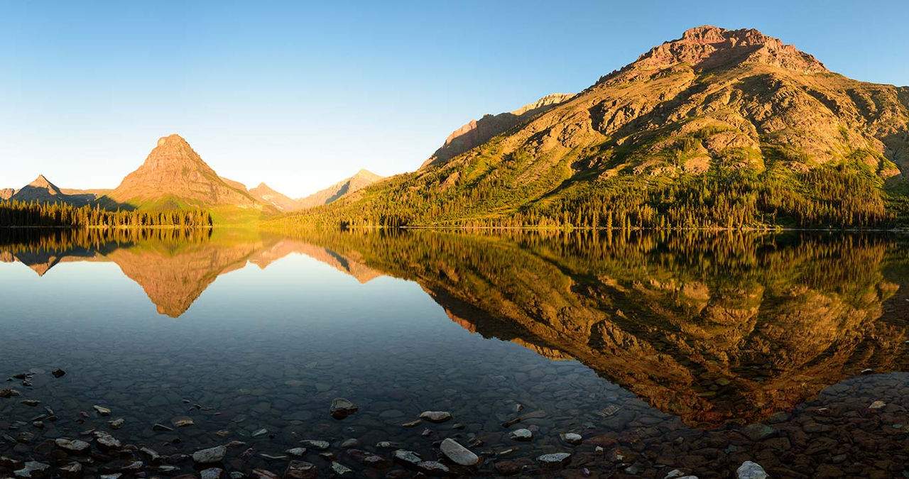 Stunning reflections on Two Medicine Lake in northern Montana at sunrise